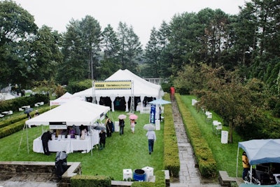 Event sponsors set up tents on the lawn, providing shelter from the rain.