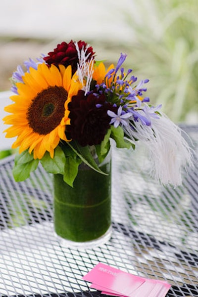 Sunflower centrepieces from Pink Twig Floral Boutique topped tables on the patio overlooking the grounds.