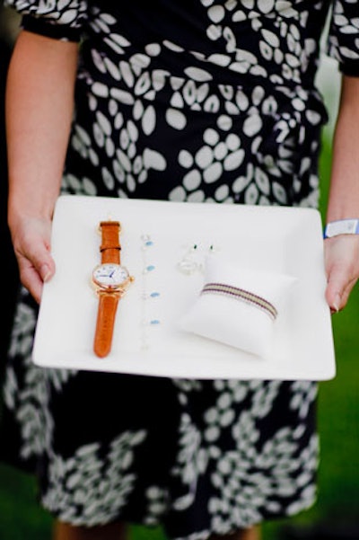 A volunteer wandered around the garden, displaying the Links of London raffle items to guests during the event.