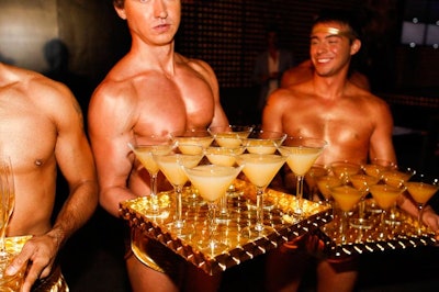 Bronzed male servers in gold shorts served screwdriver and greyhound cocktails.