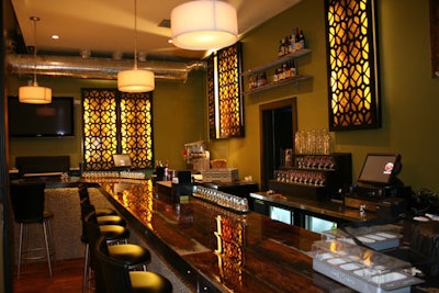 Stained glass and wrought iron light boxes decorate the 30-foot bar, which is made from reclaimed barn wood.