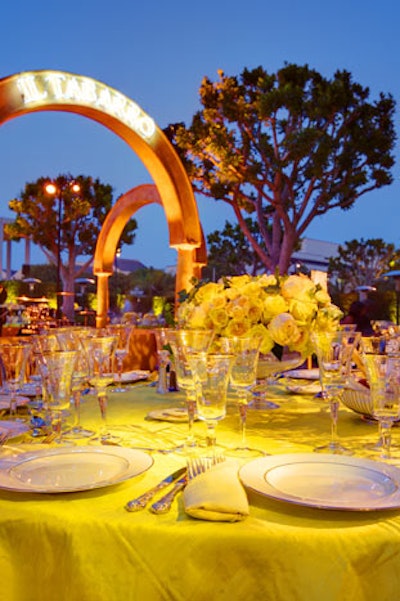 Flower arrangements and gold-rimmed crystal and china topped buttery raw-silk tablecloths.