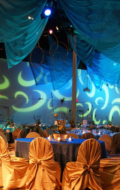 AVSS Inc. used theatrical lighting to accent the draping and golden table linens.