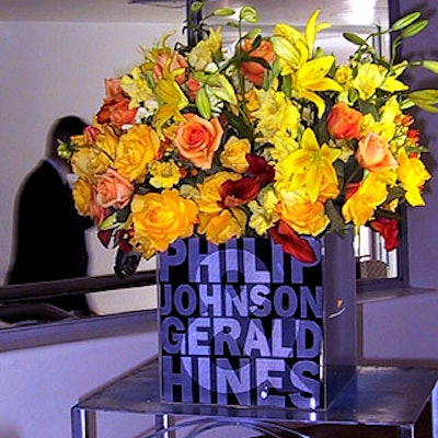 Susan Edgar Design provided the bright yellow flower arrangements contained in Plexiglas boxes with Hines and Johnson's names on the front.