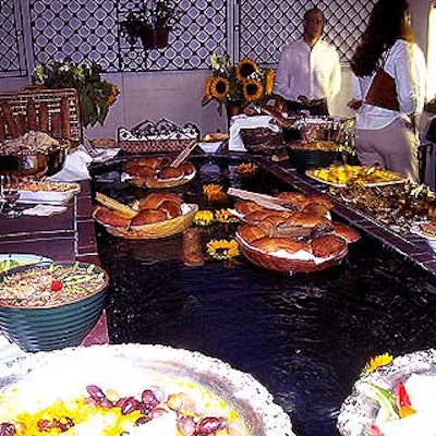 On one of the outdoor patios overlooking the water, trays of bread floated in a fountain surrounded by other buffet foods.