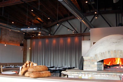 Guests can watch pizzas baking in the domed, wood-burning brick oven.