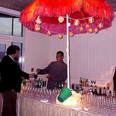 Colorful beach umbrellas with hanging polka-dotted paper ball lights, yellow shovels and green pails with Register.com’s logo also decorated the large food buffet tables.