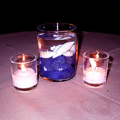 The dining tables were decorated with sand-colored tablecloths and vases filled with water, seashells and pieces of sea glass surrounded by three small candles.