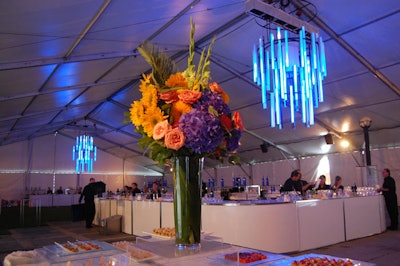 The purple, pink, and orange hues displayed in floral arrangements from Emblem coordinated with the changing colours in the LED chandeliers.