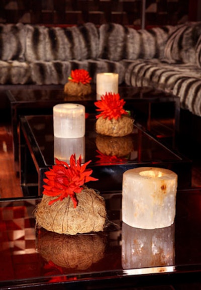 Candles and simple red flowers decked tabletops.