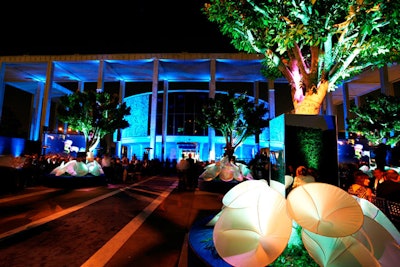 Mirrors and fabric flowers decorated tree planters in the courtyard of the theater.