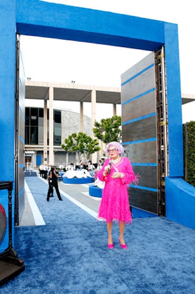 Dame Edna came through huge wooden doors, inviting guests to be seated for dinner.