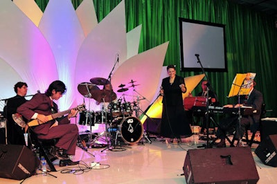 During the V.I.P. cocktail reception, a samba band performed on a stage decorated by a fan-shaped backdrop lit with tropical colors.