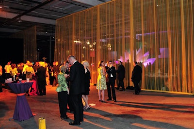 Sheer fabrics were hung from the ceiling to section off areas of the warehouse.