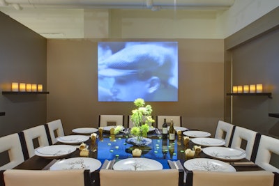 Haptor and Barrett projected black-and-white films from the 1920s against the wall behind its minimalist table.