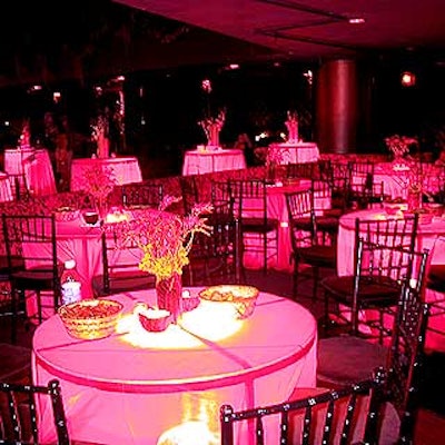 At the Planet of the Apes premiere after-party at Roseland Ballroom, cocktail tables covered with red tablecloths were underlit by spotlights by World of Illumination.