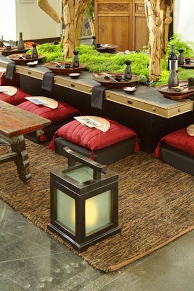 Instead of suspending lanterns over the table, where they would have competed for attention with a large driftwood horse centerpiece, Paige and Coleman's designers placed two large lanterns on the outer corners of a rug.