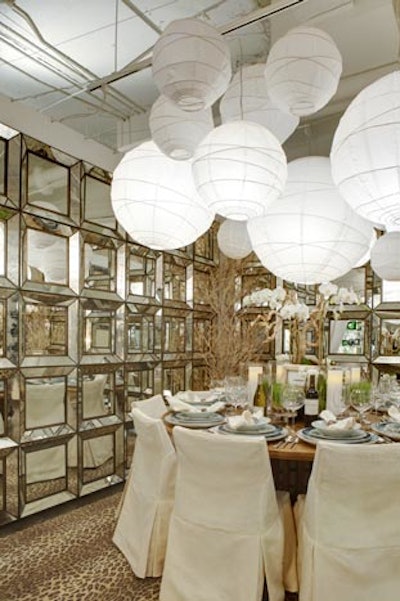A cluster of white paper lanterns in various sizes hung above Barclay Butera's table.