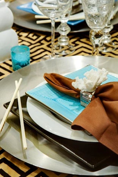 Aqua plates and napkin rings decorated with white coral evoked the sea at Paul Bott's table.