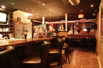 Seats at the large wooden bar offer views of multiple television broadcasts.