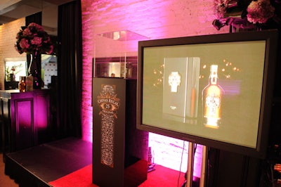 A small stage area was furnished with a flat-screen TV and a display of Chivas Regal 25.