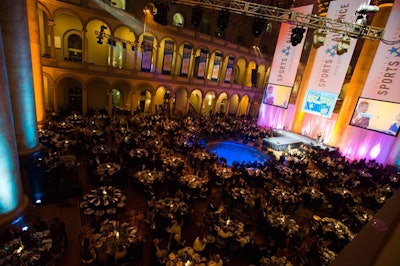 Dinner tables filled the National Building Museum while video screens and the event's logo adorned the main stage.