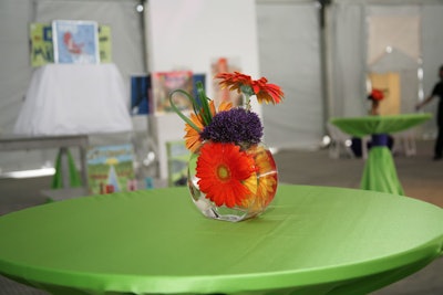 The cocktail reception was held in the same tent that housed the art gallery. Flower-adorned highboys were staggered throughout the space.