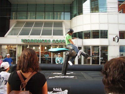 Contestants rode an oversize Schick razor—similar to a mechanical bull—outside the Score's new studio.