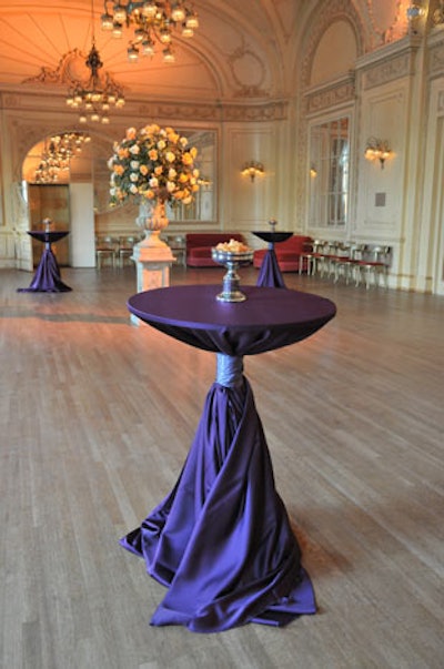 At the Symphony Center cocktail reception, highboys swathed in plum linens and orange and white roses played off the invite's color scheme.