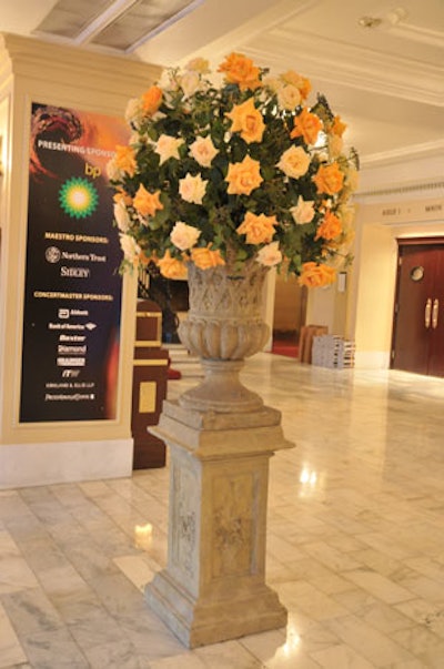 Kehoe's arrangements of orange and white roses were inspired by the swirling northern lights pattern that adorned the gala's invites and appeared on signage at the event.