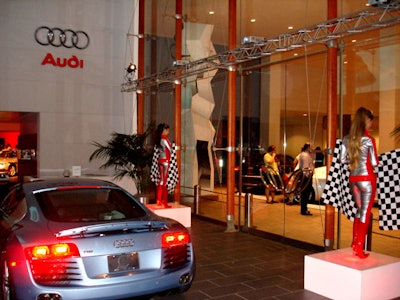 Checkered-flag-bearing models greeted guests.