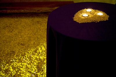 Cocktail tables had miniature mounds of yellow pebbles to mimic Rondinone's courtyard installation.