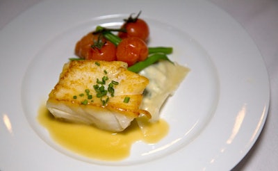 Taste Caterers served an entree of pan-seared cod with Tuscan salsa verde, house-made spinach ricotta ravioli with nutmeg, and roasted tomatoes with haricots verts.