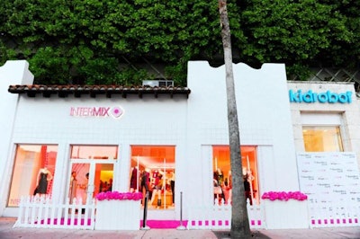 The pink-carpeted entrance was lined with a white picket fence outfitted with filled pink flower boxes courtesy of Pistils & Petals .