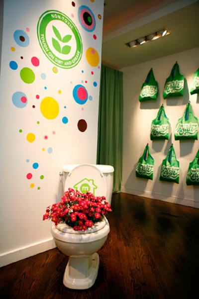 Installations such as a flower-filled toilet decorate the space.