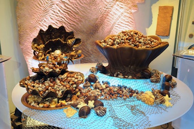 For dessert, the Dinosaur Hall featured a centerpiece of giant clam shells made of chocolate, each filled with chocolates and truffles in seashell shapes, along with ribbons of chocolate for decoration.