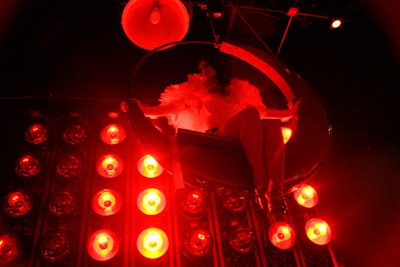 A performer swung seductively over the crowd in a half-moon swing.
