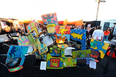 An area outside the entrance to the tent featured desks decorated with Haring-like artwork.