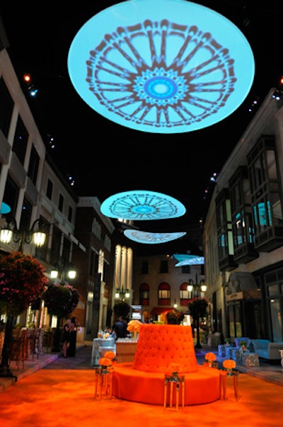 Round screens suspended above the street popped over carpeted zones of color.