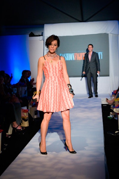 Parker Posey and Fox-5 news anchor Will Thomas co-hosted the Fashion Fights Poverty runway show.