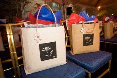 Gift bags decorated with red, white, and blue tissue paper and filled with beauty items could be found on each seat.