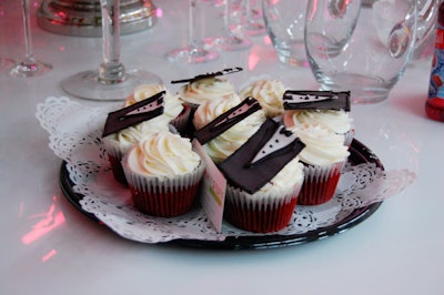 Cupcakes decorated with tuxedo shirts topped tables in the V.I.P. area.