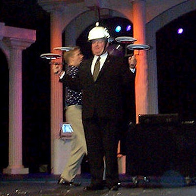 The finale of Passing Zone's performance had MPI chairman Jerry Wayne juggling plates for the crowd of meeting professionals. (Photo by EventWeb Newsletter)