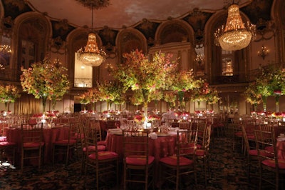 At the dinner tables, vases filled with raspberry roses complemented orange-and-pink mini-check linens.