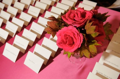 Vases filled with raspberry roses—also found on the dinner tables—decorated the place-card table at the Hilton Chicago.