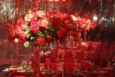 Arrangements of open roses towered over tables.
