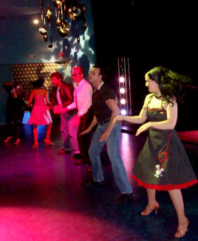 Costumed performers from ME Productions performed classic 50s dances like the Hand Jive in the prom-themed room.