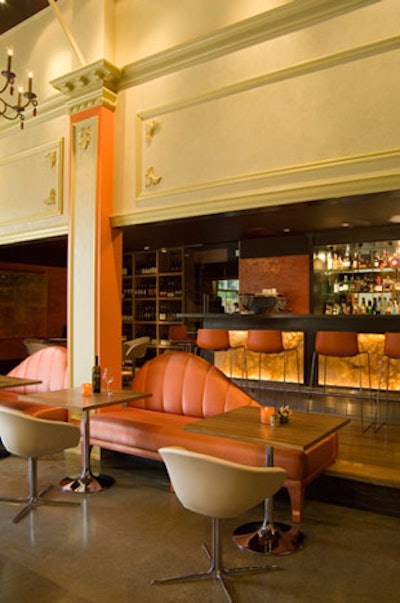A pair of custom chaise lounges act as a divider between the restaurant and bar.