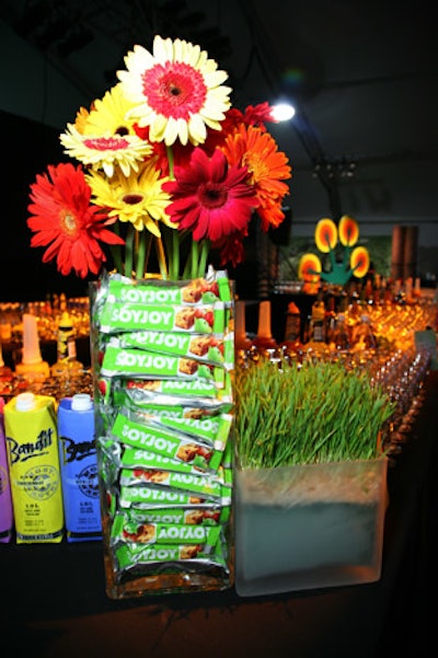 Soyjoy bars decorated vases full of colorful gerbera daisies at the Fashionably Natural show.