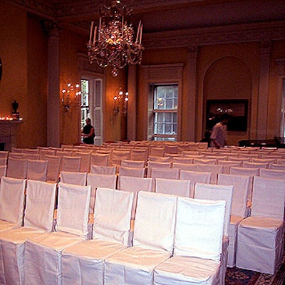 For the ceremony in the yellow-walled ballroom, guests sat on chairs from TriServe covered in cream-colored burlap.